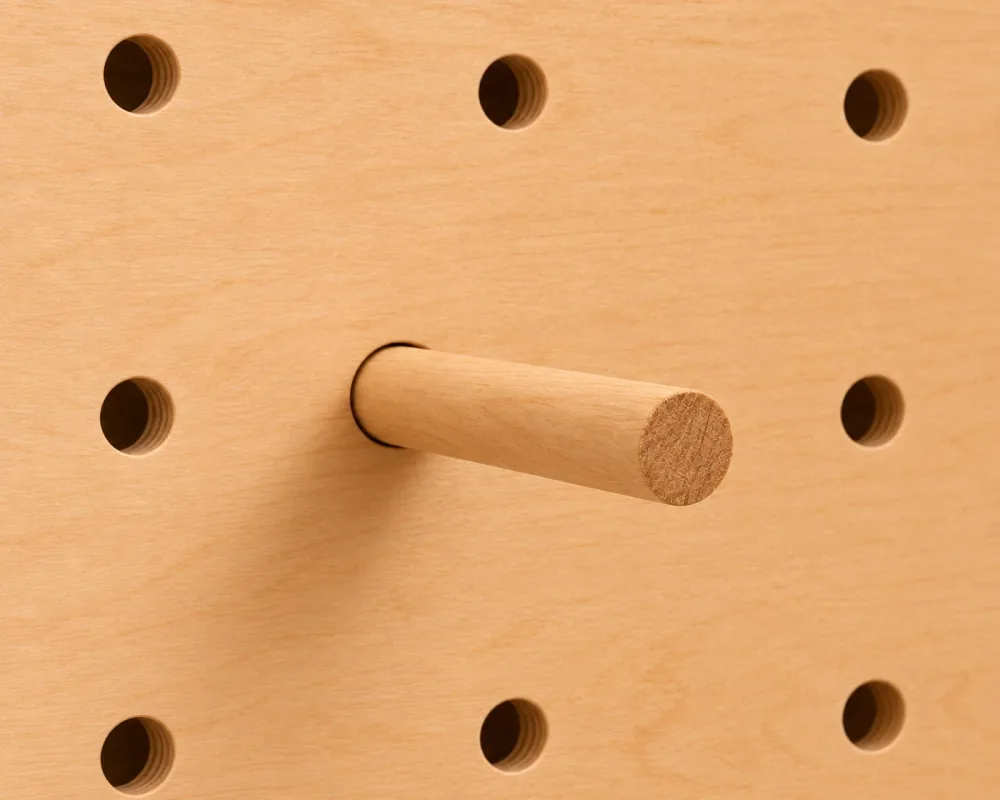 A wooden peg in a Baltic birch pegboard