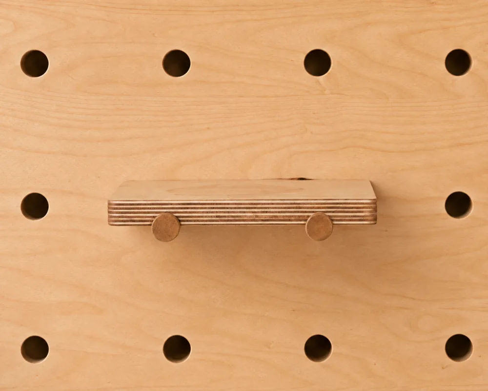 A small shelf on a Baltic birch pegboard